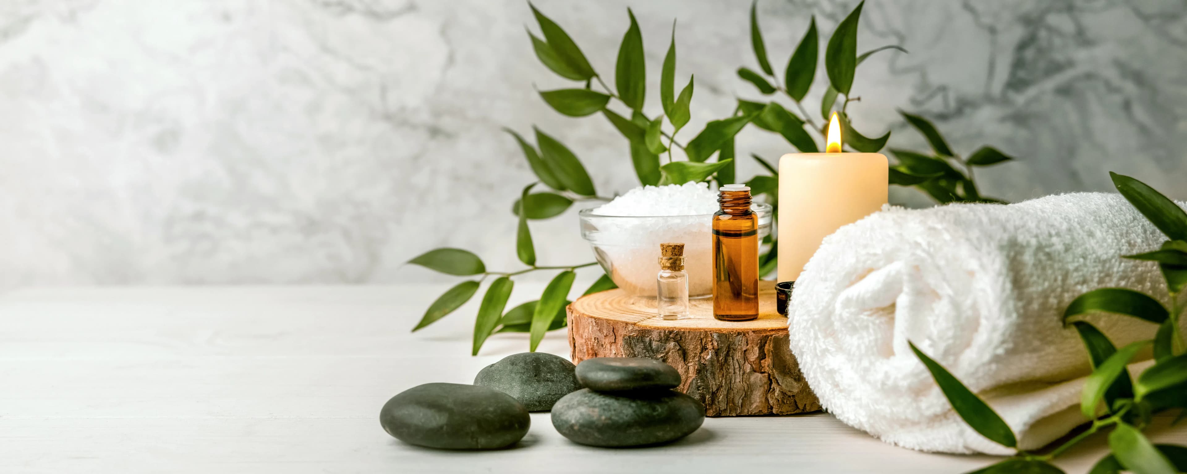 image of a towel, candle and hot stones