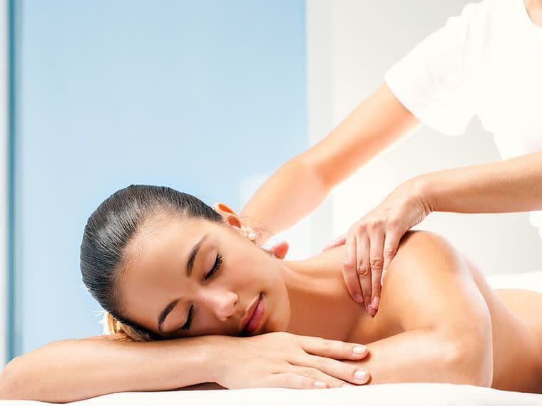 image of a woman laying on a massage table having swedish massage